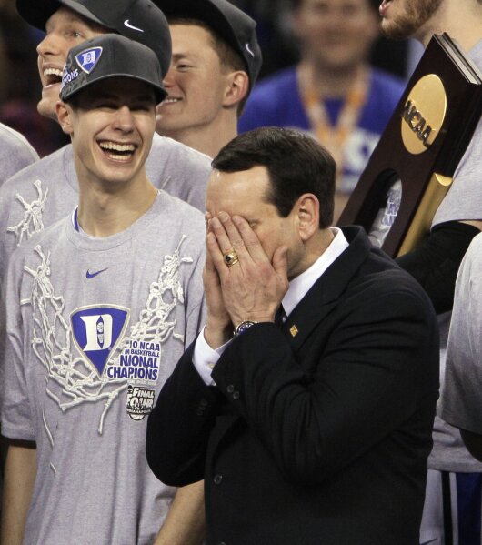 FILE - In this April 5, 2010, file photo, Duke head coach Mike Krzyzewski is overcome with emotion after Duke's 61-59 win over Butler in the men's NCAA Final Four college basketball championship game in Indianapolis. At left is Duke guard Jon Scheyer. (AP Photo/Amy Sancetta, Fle)