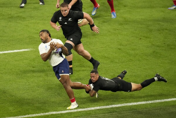 France's Peato Mauvaka is tackled by New Zealand's Aaron Smith during the Rugby World Cup Pool A match between France and New Zealand at the Stade de France in Saint-Denis, north of Paris, Friday, Sept. 8, 2023. (AP Photo/Themba Hadebe)