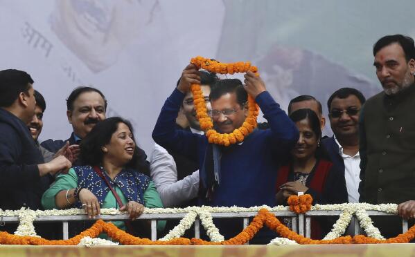 Incumbent Delhi Chief Minister Arvind Kejriwal, center, is garlanded at Aam Aadmi Party, or "common man's" party headquarters as they celebrate the party's victory in New Delhi, India, Tuesday, Feb. 11, 2020. Indian Prime Minister Narendra Modi's Hindu nationalist party was facing a stunning defeat by a regional party Tuesday in elections in the national capital that were seen as a referendum on Modi's policies such as a new national citizenship law that excludes Muslims. (AP Photo/Manish Swarup)