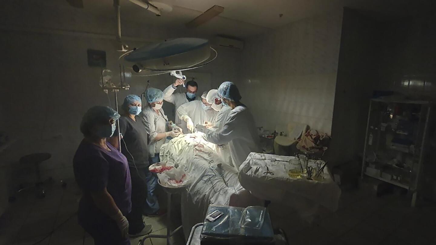 Surgeons work by flashlight as Ukraine power grid battered