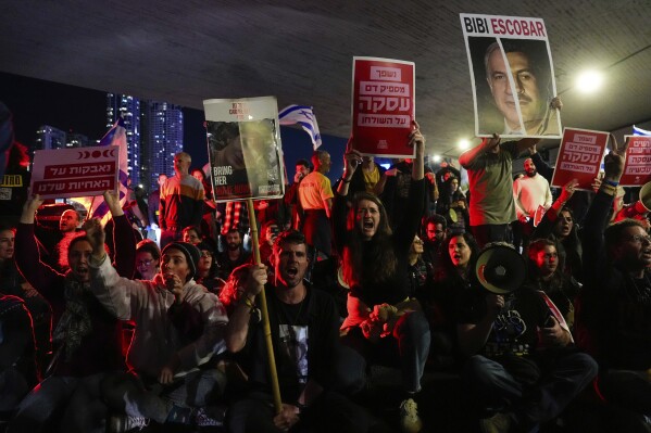 Relatives and supporters of the Israeli hostages held in the Gaza Strip by the Hamas militant group block a road during a rally calling for their release, in Tel Aviv, Israel, Saturday, March 16, 2024. (AP Photo/Ohad Zwigenberg)