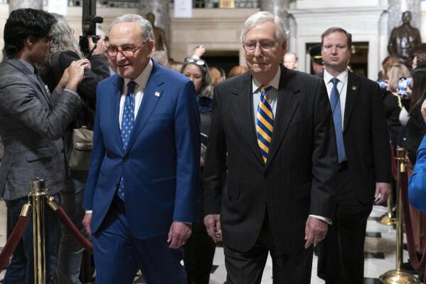 Senate Majority Leader Chuck Schumer, D-N.Y., left, accompanied by Senate Minority Leader Mitch McConnell, R-Ky., arrive for President Joe Biden's State of the Union address to a joint session of Congress at the Capitol, Tuesday, Feb. 7, 2023, in Washington. (AP Photo/Jose Luis Magana)