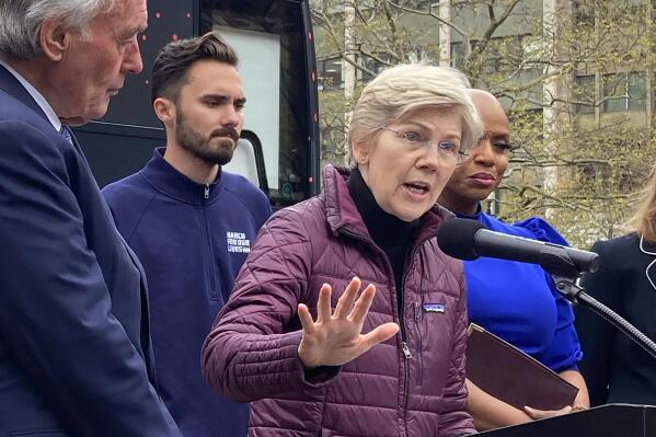 U.S. Sen. Elizabeth Warren, D-Mass., center, faces reporters as Sen. Edward Markey, D-Mass., left, and David Hogg, gun control activist and survivor of the the Stoneman Douglas High School shooting, second from left, look on during a news conference, Monday, April 24, 2023, in Boston. Warren and Markey pushed for changes to the Supreme Court that would include tougher ethics oversight following revelations of business transactions and travel involving Justice Clarence Thomas that Thomas did not disclose. (AP Photo/Steve LeBlanc)
