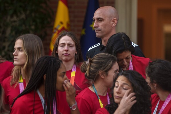FILE - President of Spain's soccer federation, Luis Rubiales stands with Spain's Women's World Cup soccer team after being received by Spain's Prime Minister Pedro Sanchez at La Moncloa Palace in Madrid, Spain, Tuesday, Aug. 22, 2023. The kiss by Luis Rubiales has unleashed a storm of fury over gender equality that almost marred the unprecedented victory but now looks set to go down as a milestone in both Spanish soccer history but also in women's rights.(AP Photo/Manu Fernandez, file)