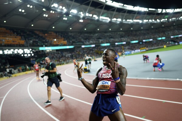 Grant Holloway, of the United States, reacts after winning the gold medal in the Men's 110-meter hurdles final during the World Athletics Championships in Budapest, Hungary, Monday, Aug. 21, 2023.(AP Photo/Bernat Armangue)