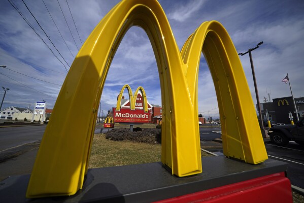 FILE - McDonald's restaurant signs are shown in in East Palestine, Ohio, Feb. 9, 2023. Krispy Kreme stock jumped Tuesday, March 26, 2024, after it announced a deal where McDonald’s restaurants will sell its doughnuts across the country.(AP Photo/Gene J. Puskar, File)