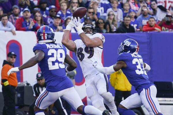 Baltimore Ravens' Mark Andrews (89) catches a pass for a touchdown in front of New York Giants' Xavier McKinney (29) and Fabian Moreau (37) during the second half of an NFL football game Sunday, Oct. 16, 2022, in East Rutherford, N.J. (AP Photo/Seth Wenig)