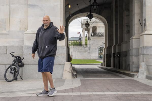 FILE - Sen. John Fetterman, D-Penn., waves to members of the media, Monday, April 17, 2023, on Capitol Hill in Washington, as he returns to the Capitol after seeking inpatient treatment for clinical depression. (AP Photo/Jacquelyn Martin, File)