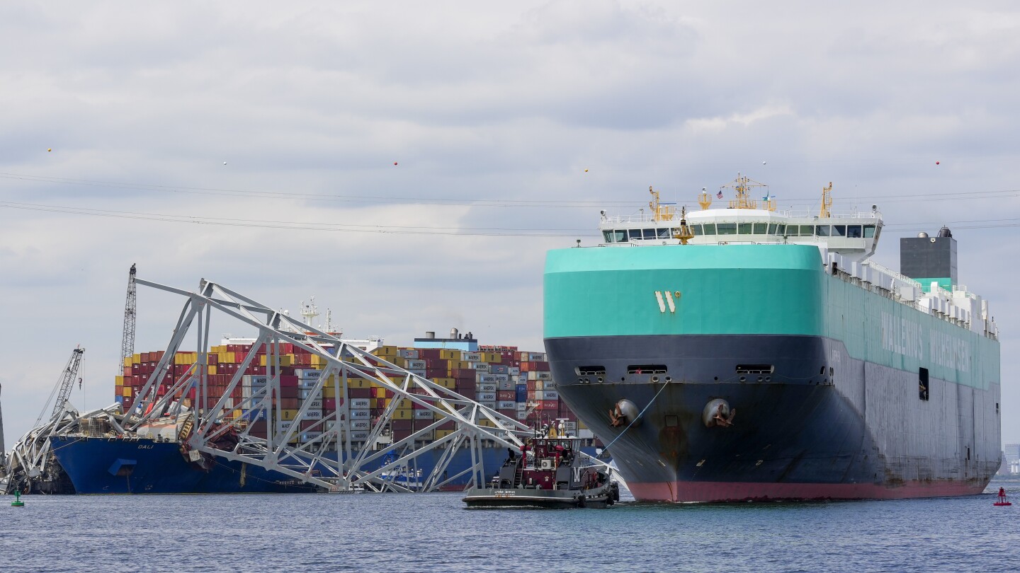 A cargo vessel moves through a newly opened deep-water channel in Baltimore after being stuck in the harbor since the Francis Scott Key Bridge collaps