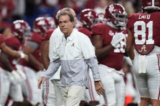 FILE - Alabama coach Nick Saban watches players warm up for the College Football Playoff championship NCAA football game against Georgia on  Jan. 10, 2022, in Indianapolis. Saban is concerned about the current state of college football. He recently told The Associated Press "I don't think what we’re doing right now is a sustainable model.” (AP Photo/Paul Sancya, File)