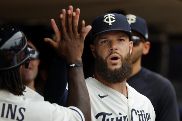 Minnesota Twins starting pitcher Dallas Keuchel celebrates with his team in the seventh inning of a baseball game, Sunday, Aug. 20, 2023, in Minneapolis. (AP Photo/Bruce Kluckhohn)