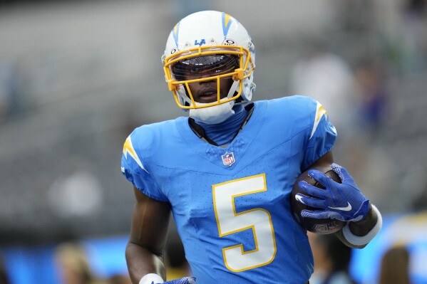 FILE -Los Angeles Chargers wide receiver Joshua Palmer (5) warms up before an NFL football game against the Las Vegas Raiders, Sunday, Oct. 1, 2023, in Inglewood, Calif. Joshua Palmer has returned to practice for the Los Angeles Chargers Wednesday, Dec. 6, 2023, giving the team's beleaguered receiving group a bit of good news.(AP Photo/Ashley Landis, File)