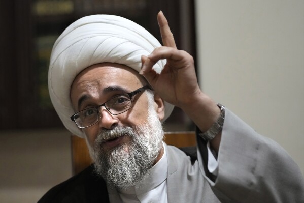 Shiite cleric Yasser Auda gestures as he speaks during an interview with The Associated Press, at his house in the southern suburb of Beirut, Lebanon, Friday, Aug. 18, 2023. Auda, who has angered politicians and religious leaders in Lebanon and Iraq by his harsh criticism says groups including Lebanon's Hezbollah are trying to silence voices of dissent within the sect including his days after he almost stripped of his religous status. (AP Photo/Hussein Malla)
