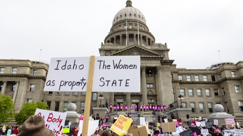 FILE - An attendee at Planned Parenthood's Bans Off Our Bodies rally for abortion rights holds a sign reading outside of the Idaho Statehouse in downtown Boise, Idaho, on May 14, 2022. Two advocacy groups and an attorney who works with sexual assault victims are suing Idaho over a new law that makes it illegal to help minors get an abortion without their parents’ consent. (Sarah A. Miller/Idaho Statesman via AP, File)