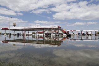 FILE - In this May 10, 2019 file photo, a Sapp Bros. gas station in Percival, Iowa, stands in floodwaters from the Missouri River. Republican senators from four states that have seen severe flooding from the Missouri River are backing legislation that would require the U.S. Army Corps of Engineers to change its management of the river to reduce flooding risk. The measure, which was introduced Thursday, March, 5, 2020, follows criticism from residents of flooded areas that the Corps should give flood protection a higher priority than environmental, recreational and other needs. (AP Photo/Nati Harnik, File)