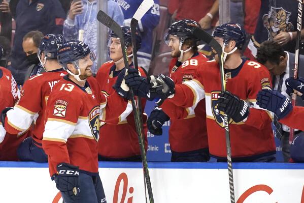 Florida Panthers center Sam Reinhart (13) is congratulated after scoring a goal during the first period of an NHL hockey game against the Vancouver Canucks, Tuesday, Jan. 11, 2022, in Sunrise, Fla. (AP Photo/Lynne Sladky)