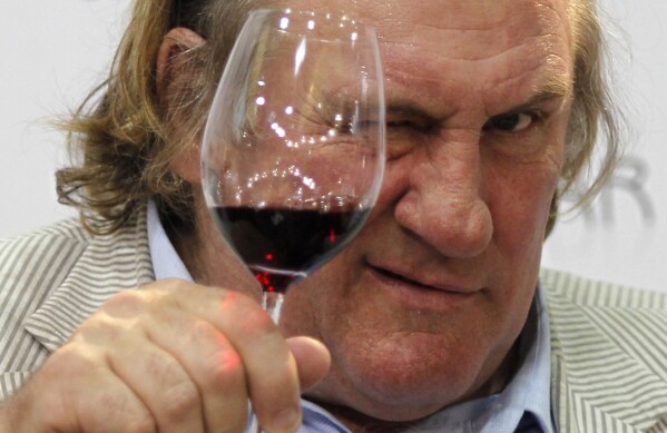 French actor Gerard Depardieu tests a glass of wine during a gastronomy fair in Duesseldorf, Germany, on Sept 12, 2010. (AP Photo/Roberto Pfeil/dapd, File)