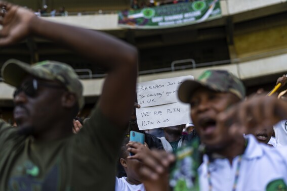 Supporters of former South African President Jacob Zuma hold a pro-Putin sign at Orlando stadium in the township of Soweto, Johannesburg, South Africa, for the launch of his newly formed uMkhonto weSizwe (MK) party's manifesto Saturday, May 18, 2024. Zuma, who has turned his back on the African National Congress (ANC) he once led, will face South African President Cyril Ramaphosa, who replaced him as leader of the ANC in the general elections later in May. (AP Photo/Jerome Delay)