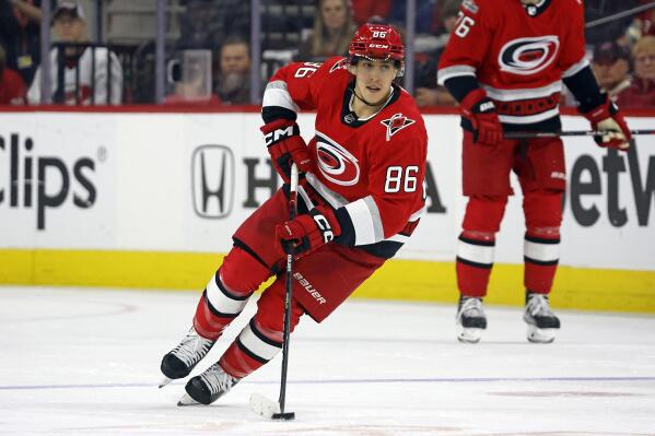FILE - Carolina Hurricanes' Teuvo Teravainen skates with the puck during the second period of Game 2 in the team's NHL hockey Stanley Cup first-round playoff series against the New York Islanders in Raleigh, N.C., April 19, 2023. Teravainen's roughly month-long absence due to injury could be nearing an end. The Carolina Hurricanes forward has shed his no-contact jersey and participated in a full practice Monday, May 15, ahead of the Eastern Conference final against Florida. Teravainen hasn't played since he suffered a thumb injury early in the first-round series. (AP Photo/Karl B DeBlaker, File)