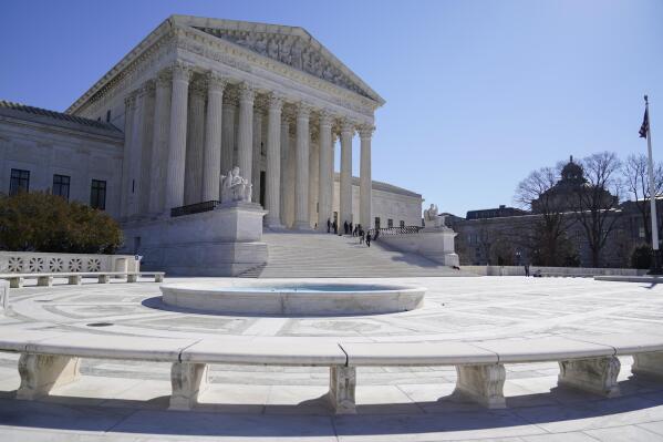 FILE - People stand on the steps of the U.S. Supreme Court, Feb.11, 2022, in Washington.  (AP Photo/Mariam Zuhaib, File)