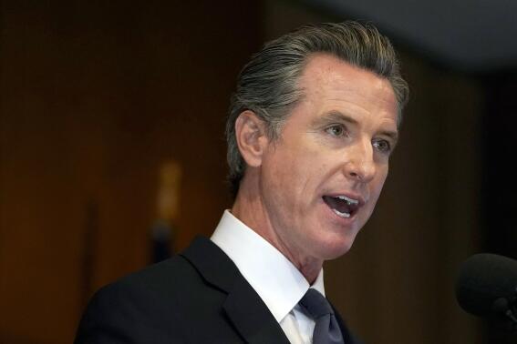 FILE - In this Sept. 14, 2021, file photo, Gov. Gavin Newsom speaks in San Francisco. California will be the first state to bar mega-retailers from firing warehouse workers for missing quotas that interfere with bathroom and rest breaks. The legislation signed Wednesday, Sept. 22, 2021 by Newsom grew from Amazon's drive to speed goods to consumers. (AP Photo/Jeff Chiu, File)