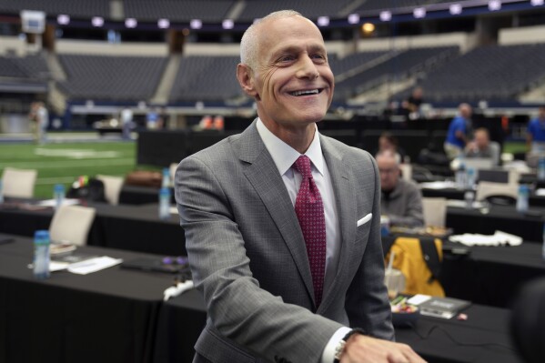 FILE - Big 12 Commissioner Brett Yormark smiles before speaking at the opening of the NCAA college football Big 12 media days in Arlington, Texas, July 12, 2023. Colorado is leaving the Pac-12 to return to the conference the Buffaloes jilted a dozen years ago, and the Big 12 celebrated the reunion with a two-word statement released through Yomark: “They’re back.” (AP Photo/LM Otero, File)
