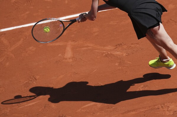 Ukraine's Elina Svitolina casts her shadow on the court as she returns the ball to Italy's Jasmine Paolini during their fourth round match of the French Tennis Open, at the Roland-Garros stadium, in Paris, Sunday, June 1 2025. (AP Photo/Christophe Ena)