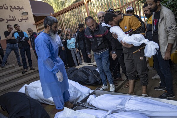 Palestinians mourn their relatives killed in the Israeli bombardment of the Gaza Strip, in the hospital in Khan Younis, Saturday, Nov. 18, 2023. (AP Photo/Fatima Shbair)