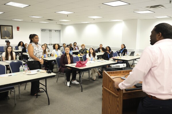 In this photo provided by the American Academy of Dermatology, Dakota Sutton and AAD Pathways Derm Career Prep students engage with instructor Jaracus Copes, right, at the George Washington University Student Center in Washington on July 14, 2023. (Joshua Lee Reed/AAD via AP)