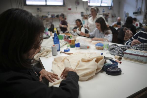 Tailors work on stage costumes in the "Teatro dell' Opera" opera house costumes laboratory, in Rome, Thursday, April 10, 2025. (AP Photo/Andrew Medichini)