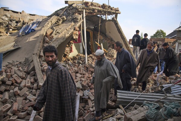 Kashmiri villager inspect the debris of the blown-up family home of Ahsan Ul Haq Shiekh, a militant who officials say is involved in the deadly attack on tourists in Pahalgam, at Murran village in Pulwama, south of Srinagar, Indian controlled Kashmir, Saturday, April 26, 2025. (AP Photo/Dar Yasin)