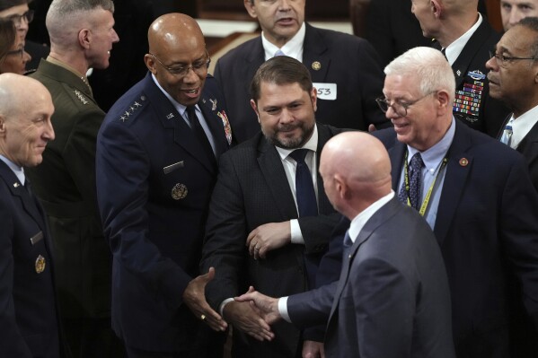Sen. Mark Kelly, D-Ariz., shakes hands with the Chairman of the Joint Chiefs of Staff Gen. CQ Brown before President Joe Biden delivers the State of the Union address to a joint session of Congress at the U.S. Capitol, Thursday March 7, 2024, in Washington. (AP Photo/Andrew Harnik)