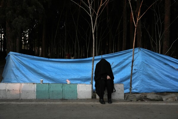 A woman weeps at the scene of Wednesday's bomb explosion in the city of Kerman about 510 miles (820 kms) southeast of the capital Tehran, Iran, Thursday, Jan. 4, 2024. Investigators believe suicide bombers likely carried out an attack on a commemoration for an Iranian general slain in a 2020 U.S. drone strike, state media reported Thursday, as Iran grappled with its worst mass-casualty attack in decades and as the wider Mideast remains on edge. (AP Photo/Vahid Salemi)