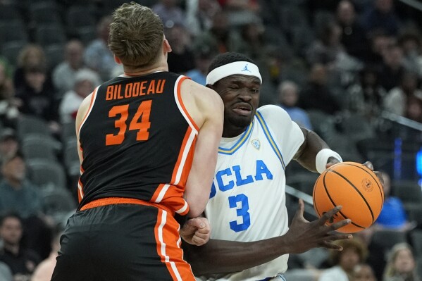 Oregon State forward Tyler Bilodeau (34) fouls UCLA forward Adem Bona (3) during the first half of an NCAA college basketball game in the first round of the Pac-12 tournament Wednesday, March 13, 2024, in Las Vegas. (AP Photo/John Locher)