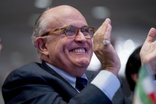 
              In this May 5, 2018 photo, Rudy Giuliani, an attorney for President Donald Trump, applauds at the Iran Freedom Convention for Human Rights and democracy at the Grand Hyatt in Washington. Giuliani’s decision to join President Donald Trump’s legal team could backfire on the former New York mayor if potential clients of his international consulting business view him as too erratic and go elsewhere for representation, according to legal experts. (AP Photo/Andrew Harnik)
            