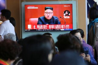 
              FILE - In this April 21, 2018 file photo, people watch a TV screen showing an image of North Korean leader Kim Jong Un during a news program at the Seoul Railway Station in Seoul, South Korea. The signs read: "North Korea says it has suspended nuclear tests." North Korea's abrupt diplomatic outreach in recent months comes after a flurry of weapons tests that marked 2017, including the underground detonation of an alleged thermonuclear warhead and three launches of developmental ICBMs designed to strike the U.S. mainland. Inter-Korean dialogue resumed after Kim in his New Year’s speech proposed talks with the South to reduce animosities and for the North to participate in February’s Winter Olympics in Pyongchang. North Korea sent hundreds of people to the games, including Kim's sister, who expressed her brother's desire to meet with Moon for a summit. South Korean officials later brokered a potential summit between Kim and Trump.  (AP Photo/Ahn Young-joon, File)
            