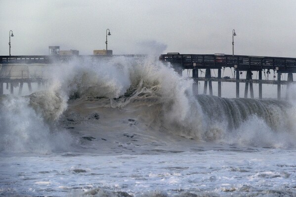 A very large wave breaks near the Ventura pier on Saturday, Dec. 30, 2023 in Ventura, Calif. Similar waves overran beaches elsewhere Thursday on the California coast, flooding parking lots, streets and triggering evacuation warnings for low-lying areas.ave energy across coastal waters. (AP Photo/Richard Vogel)