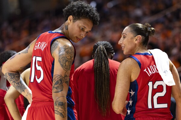 Team USA guard Diana Taurasi (12) talks with center Brittany Griner (15) during the second half of an NCAA college basketball exhibition game against Tennessee, Sunday, Nov. 5, 2023, in Knoxville, Tenn. (AP Photo/Wade Payne)