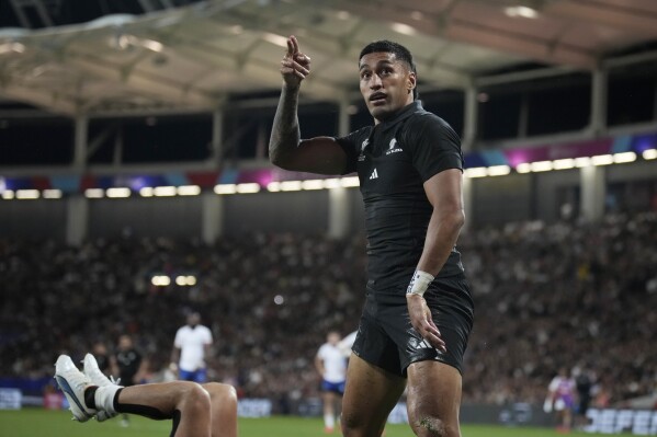 New Zealand's Rieko Ioane celebrates a try with Damian McKenzie during the Rugby World Cup Pool A match between New Zealand and Namibia at the Stadium de Toulouse in Toulouse, France, Friday, Sept. 15, 2023. (AP Photo/Christophe Ena)