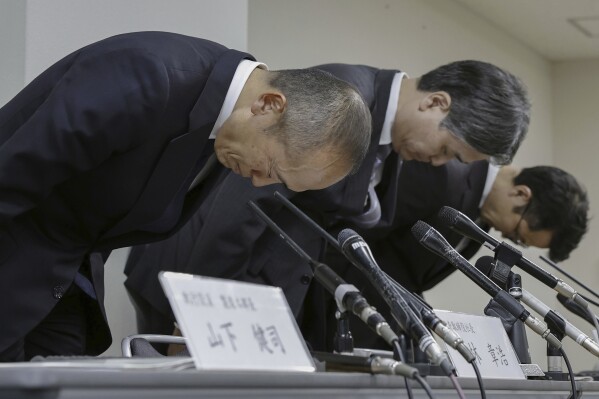 Akihiro Kobayashi, President of Kobayashi Pharmaceutical Co., left, bows during a press conference in Osaka, on March 22, 2024. Health supplement products believed to have caused a few deaths and sickened more than a hundred people have been ordered taken off store shelves in Japan. The products from Kobayashi Pharmaceutical, billed as helping lower cholesterol, contained an ingredient called “benikoji,” a red species of mold.(Chiaki Ueda/Kyodo News via AP)