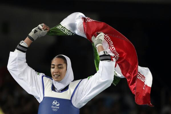 FILE - In this Aug. 18, 2016 file photo, Kimia Alizadeh Zenoorin of Iran celebrates after winning the bronze medal in a women's Taekwondo 57-kg competition at the 2016 Summer Olympics in Rio de Janeiro, Brazil. The defector from Iran who left citing institutional sexism will face the Iranian in the opening bout of their taekwondo class at the Tokyo Olympics. The draw Thursday, July 22, 2021, for the women’s 57-kilogram class placed Kimia Alizadeh of the refugee team against Nahid Kiyani Chandeh of Iran. (AP Photo/Andrew Medichini, File)