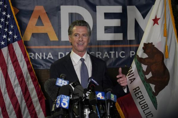 California Gov. Gavin Newsom addresses reporters, after beating back the recall attempt that aimed to remove him from office, at the John L. Burton California Democratic Party headquarters in Sacramento, Calif., Tuesday, Sept. 14, 2021. (AP Photo/Rich Pedroncelli)
