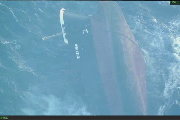 This undated photo released Sunday, March 3, 2024, by the U.S. military's Central Command shows the Belize-flagged vessel Rubymar sinking in the Red Sea. The Rubymar, earlier attacked by Yemen's Houthi rebels, has sunk in the Red Sea after days of taking on water, officials said Saturday, March 2, 2024, the first vessel to be fully destroyed as part of their campaign over Israel's war against Hamas in the Gaza Strip. (U.S. military's Central Command via AP)