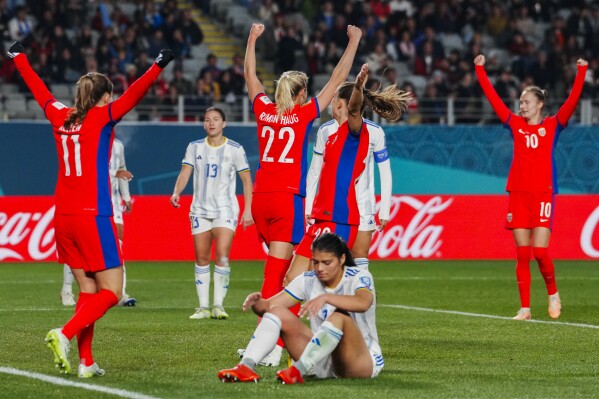 Norway players celebrate after Philippines' Alicia Barker, bottom, scored an own goal during the Women's World Cup Group A soccer match between Norway and Philippines at Eden Park stadium in Auckland, New Zealand, Sunday, July 30, 2023. (AP Photo/Abbie Parr)