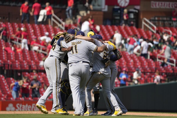 Members of the Milwaukee Brewers celebrate a 6-0 victory over the St. Louis Cardinals following a baseball game Thursday, Sept. 21, 2023, in St. Louis. (AP Photo/Jeff Roberson)