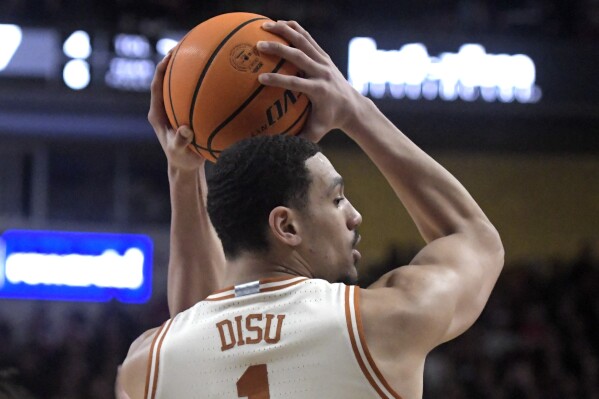 Texas' forward Dylan Disu looks to pass the ball against Texas Tech during an NCAA college basketball game, Tuesday, Feb. 27, 2024, in Lubbock, Texas. (Annie Rice/Lubbock Avalanche-Journal via AP)