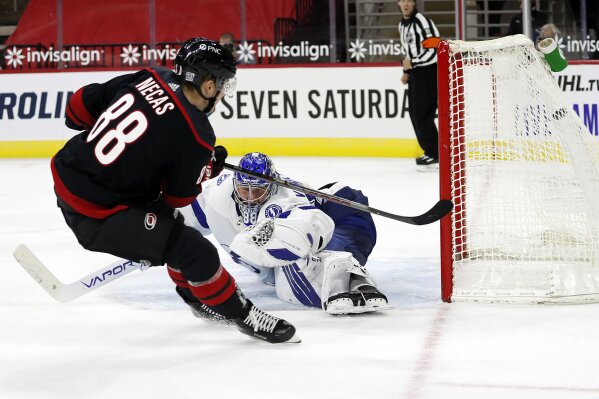 Carolina Hurricanes' Martin Necas (88) shoots the puck past Tampa Bay Lightning goaltender Andrei Vasilevskiy (88) for an overtime goal in an NHL hockey game in Raleigh, N.C., Thursday, Jan. 28, 2021. (AP Photo/Karl B DeBlaker)