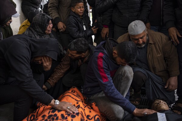 Palestinians mourn relatives killed in the Israeli bombardment of the Gaza Strip at a hospital morgue in Rafah, Tuesday, March 19, 2024. (AP Photo/Fatima Shbair)