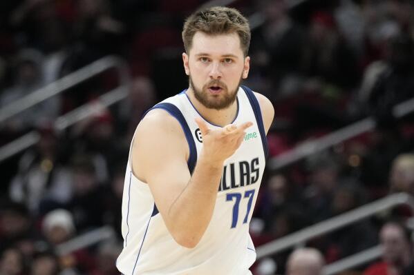 Dallas Mavericks guard Luka Doncic reacts after making a 3-point basket during the second half of an NBA basketball game against the Houston Rockets, Friday, Dec. 23, 2022, in Houston. (AP Photo/Eric Christian Smith)