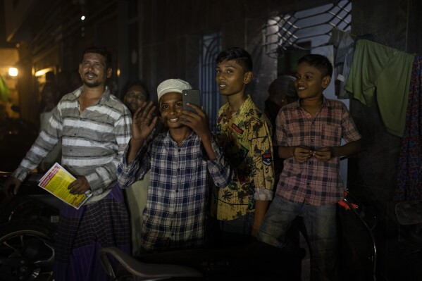 A young Muslim boy waves as Dravida Munnetra Kazhagam (DMK) party candidate Dayanidhi Maran's roadshow passes through a residential area ahead of country's general elections, in the southern Indian city of Chennai, April 14, 2024. (AP Photo/Altaf Qadri)